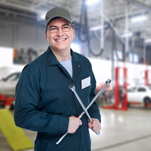 an auto mechanic with a wheel wrench